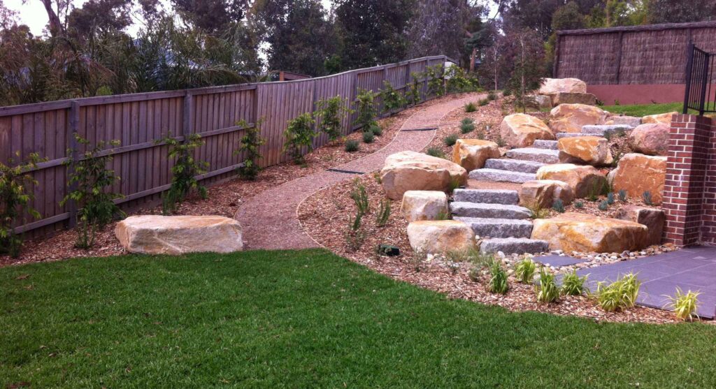 Custom garden design for an Edwardian home in Camberwell with established trees and bluestone edging.