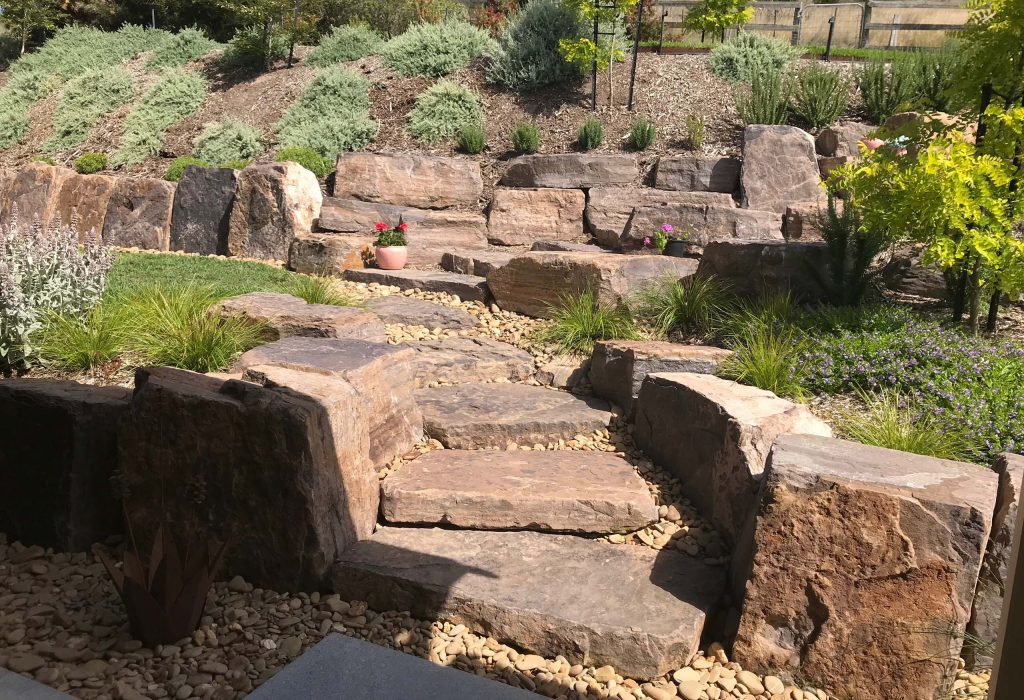 Contemporary courtyard garden for a Kew East home with bluestone paving and feature lighting.